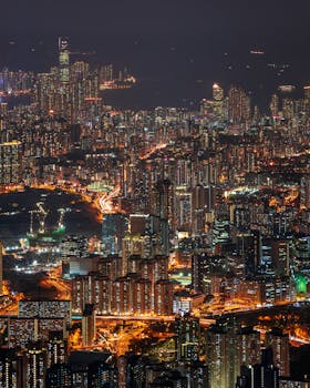 High-rise buildings and illuminated skyline of Hong Kong at night.