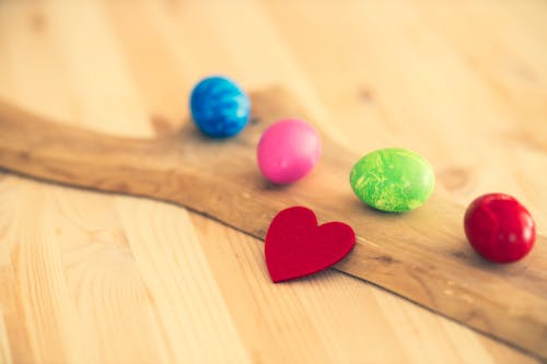 Close Up Photo of Colorful Candies on Wooden Surface