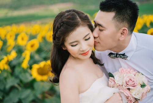 Man Kissing Woman on Her Cheek