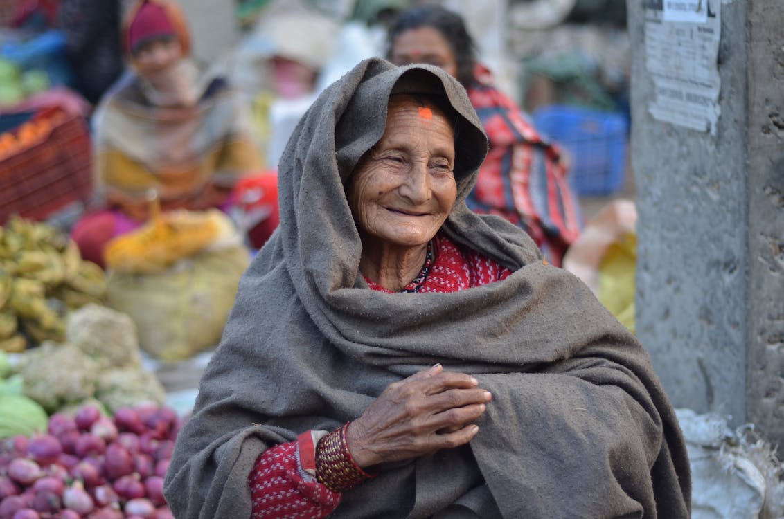 Smiling Elderly Woman Covering with Blanket