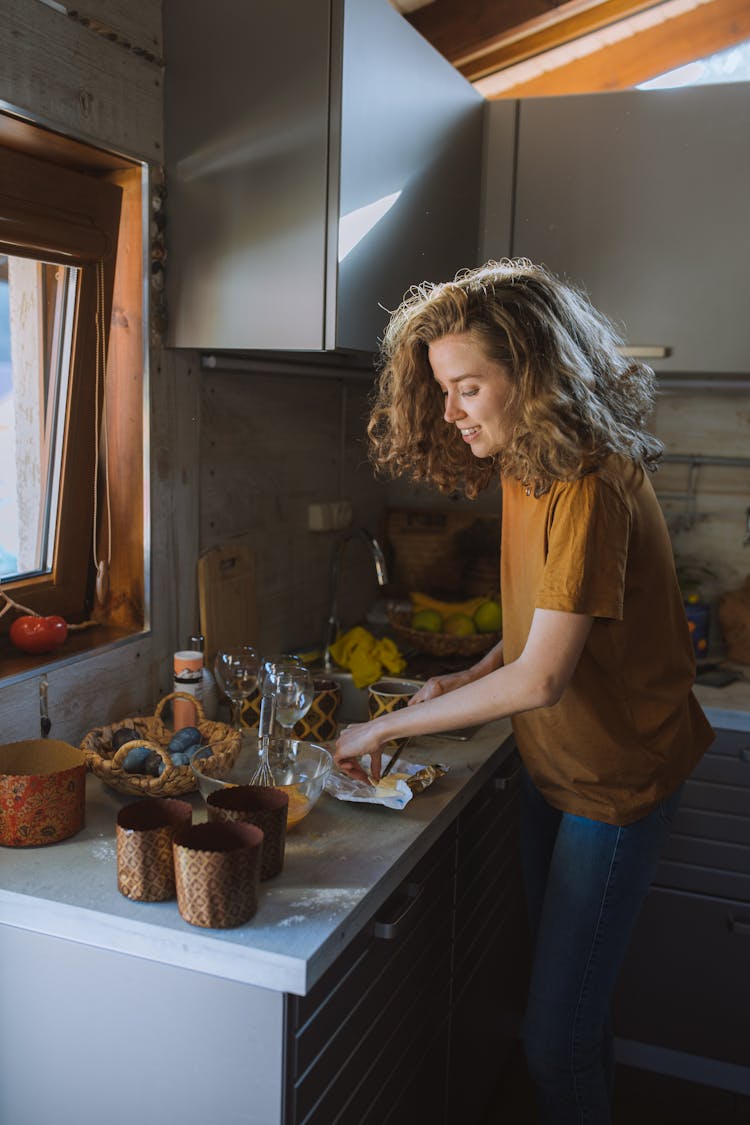 Woman In Brown Shirt Cutting Butter