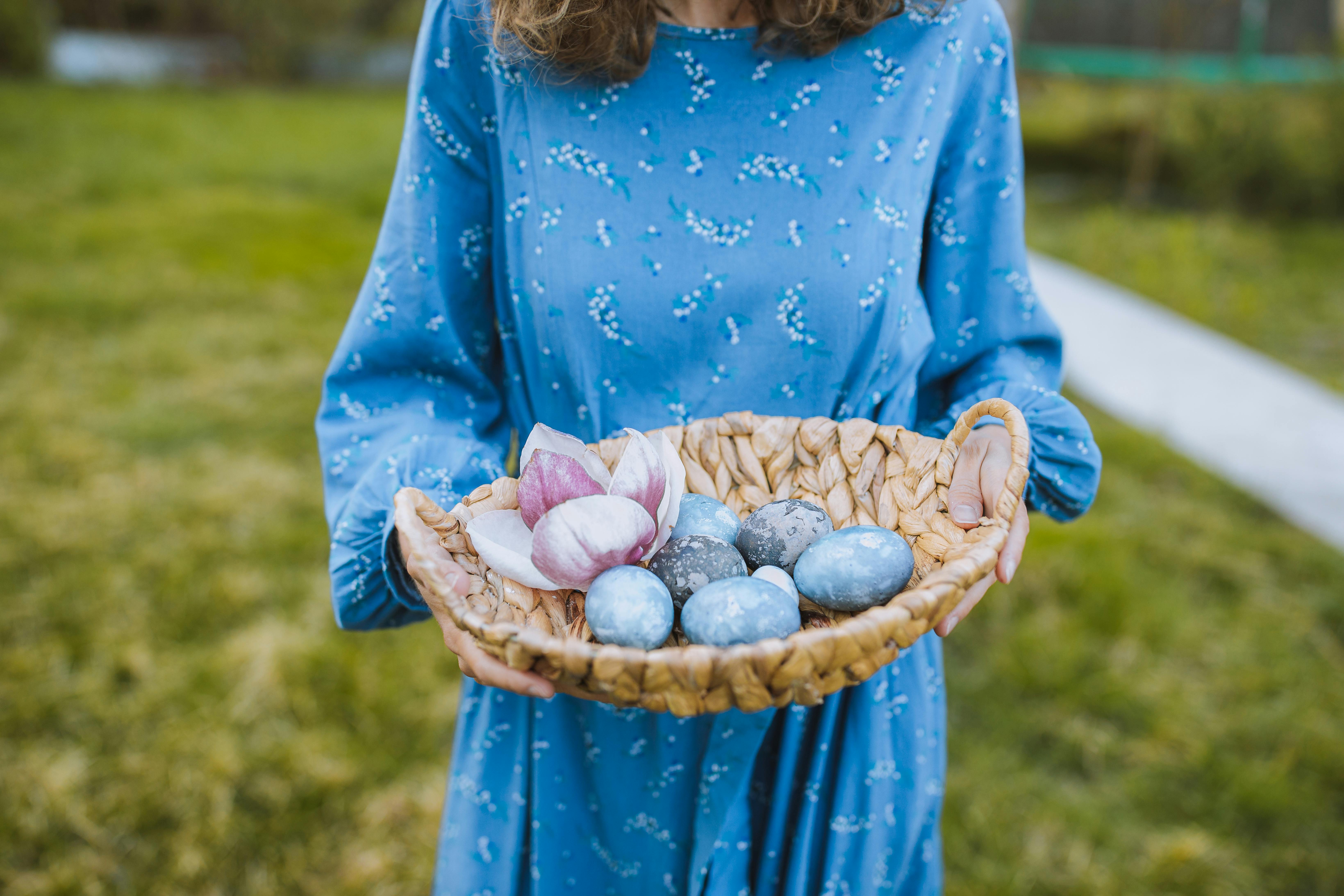 woman in blue long sleeve dress holding a basket