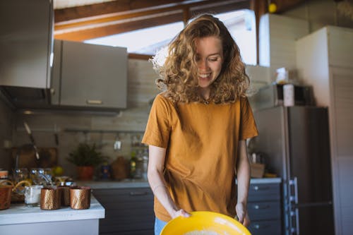 Free Woman Smiling in the Kitchen Stock Photo