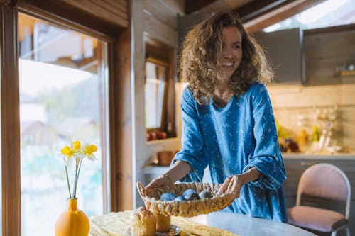 Free Smiling Woman in Blue Long Sleeve Dress Holding A Basket Stock Photo