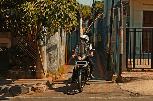 Free Man in Helmet Riding on Black Motorcycle Stock Photo