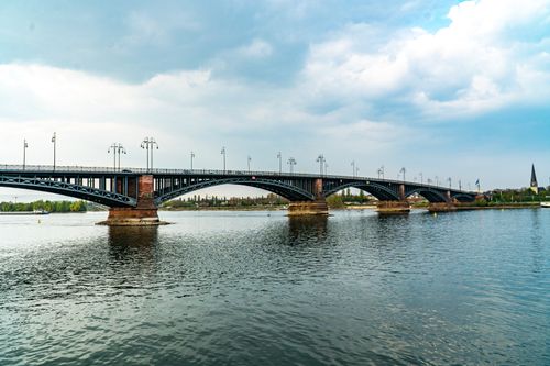 Free Steel arch bridge over the Rhine in Mainz, Germany under a cloudy sky. Stock Photo