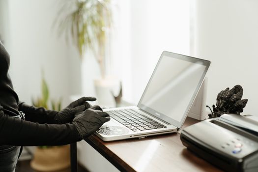 Person in Black Jacket Using Macbook Pro on Brown Wooden Table