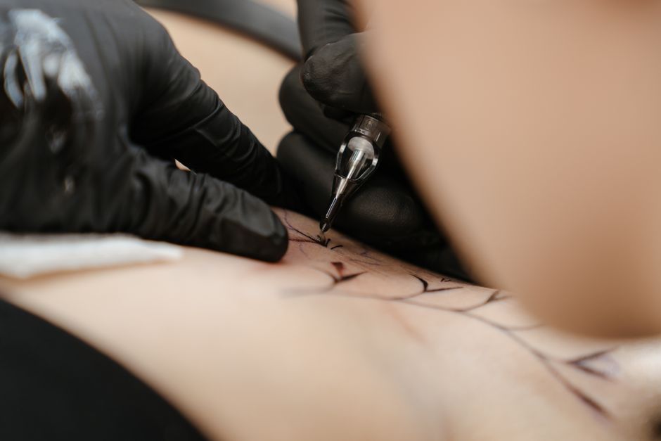 Close up of tattoo needle hitting skin texture, showing the complexity AI cannot handle.