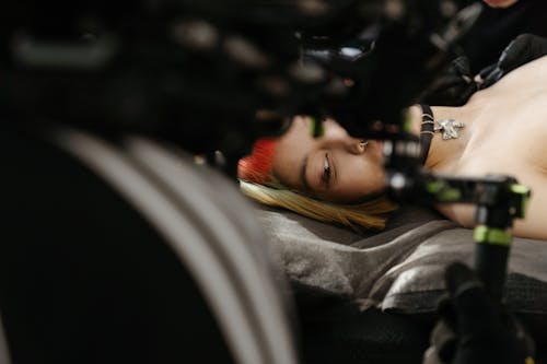 Woman in Gray Jacket Lying on Car Seat