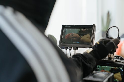 Person in Black Long Sleeve Shirt Holding Black Tablet Computer