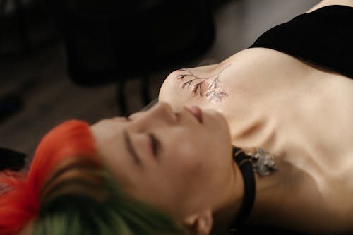 Woman in Black Tank Top Lying on Bed