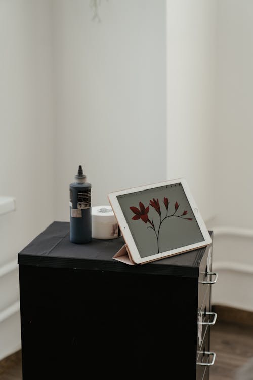 White and Red Floral Frame on Black Table