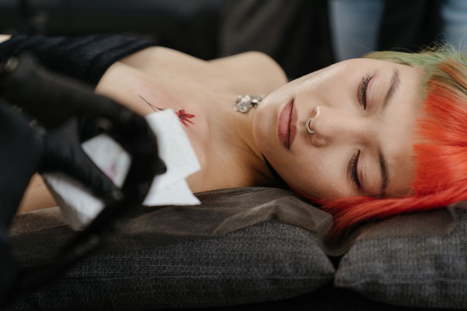 Tattoo apprentice training under an experienced mentor in a studio Tattoo apprentice training under an experienced mentor in a studio