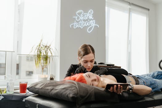 A tattoo artist inked a client with vibrant red hair in a contemporary studio.