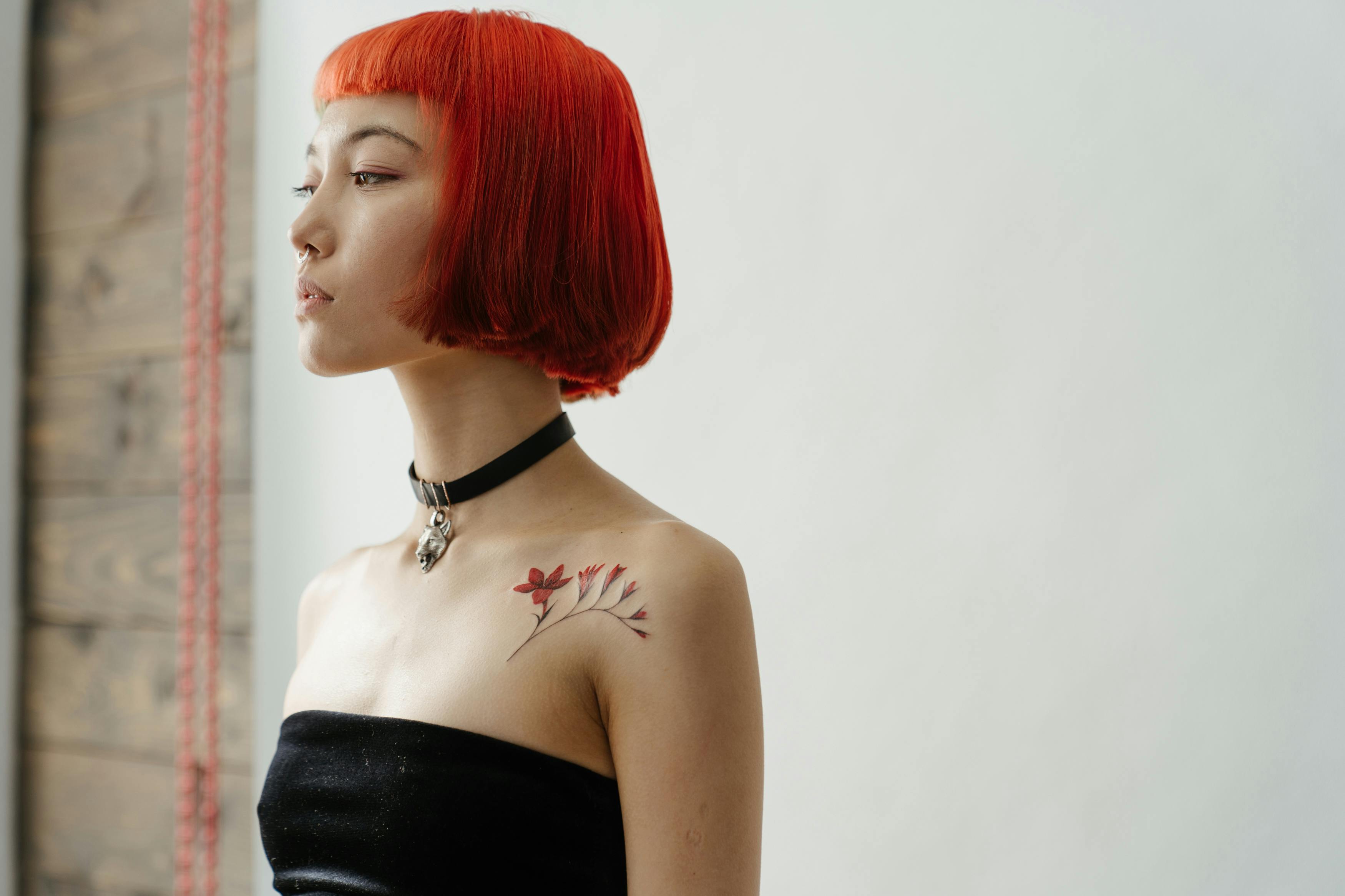 woman in black tube top with red hair