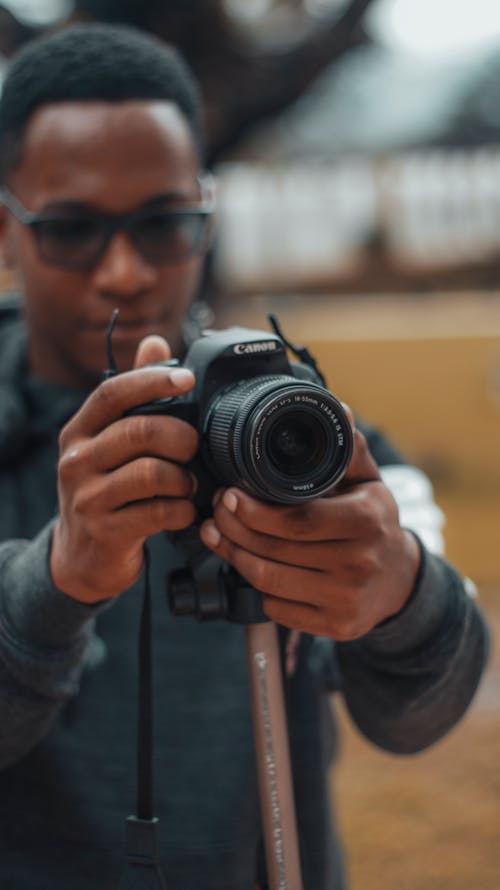 Free Photo Of Person Holding Camera Stock Photo