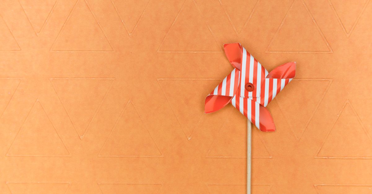 Red Color Pinwheel Red and White Pinwheel on Brown Surface · Free Stock Photo