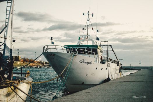 A scenic view of a fishing boat docked at the harbor in Villa San Giovanni, Calabria, Italy.