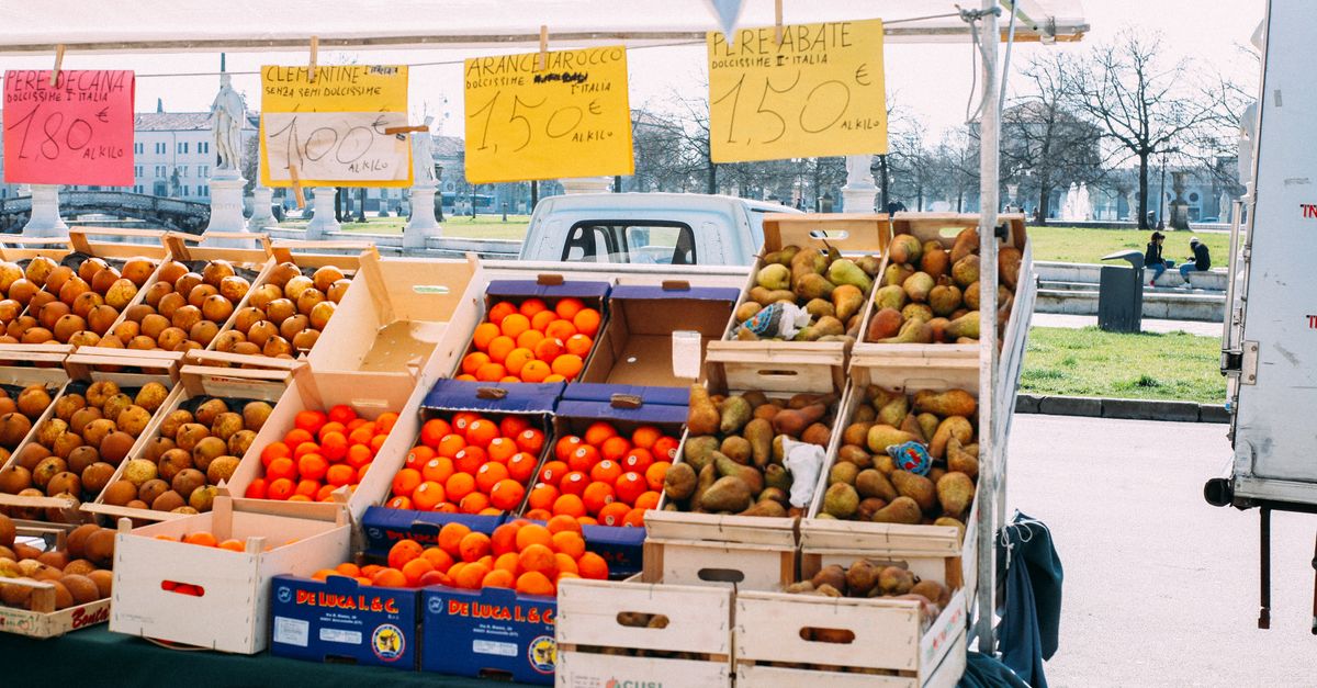 local market scene with fresh produce and vendors in European city