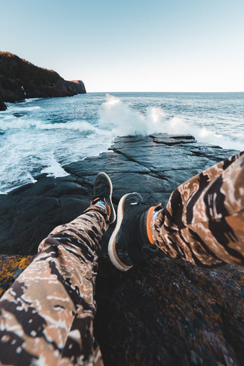 Photo Of Person Sitting On Shore