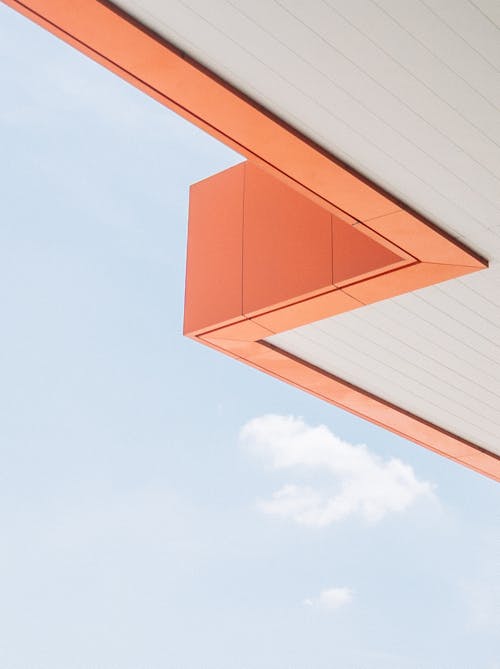 Angle of orange roof and sky with clouds