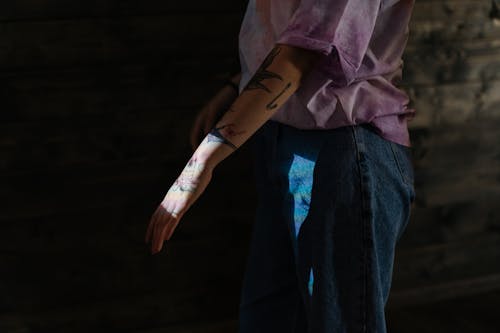 Person in Blue Denim Jeans and Brown Leather Gloves