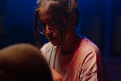 Woman in White and Pink Shirt Wearing Eyeglasses