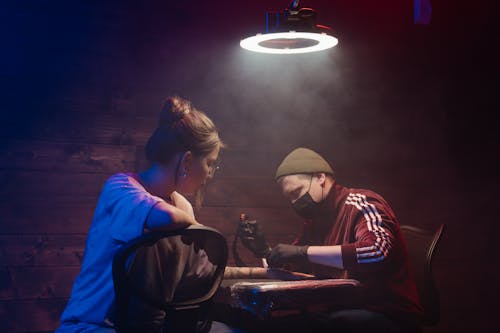 Man and Woman Sitting on Chair