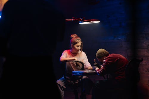 Woman in Red Jacket Sitting on Chair