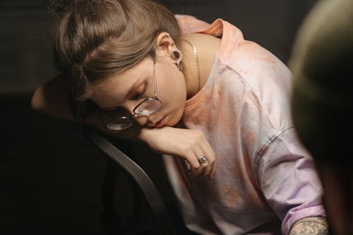 Woman in Pink Crew Neck Shirt Wearing Black Framed Eyeglasses
