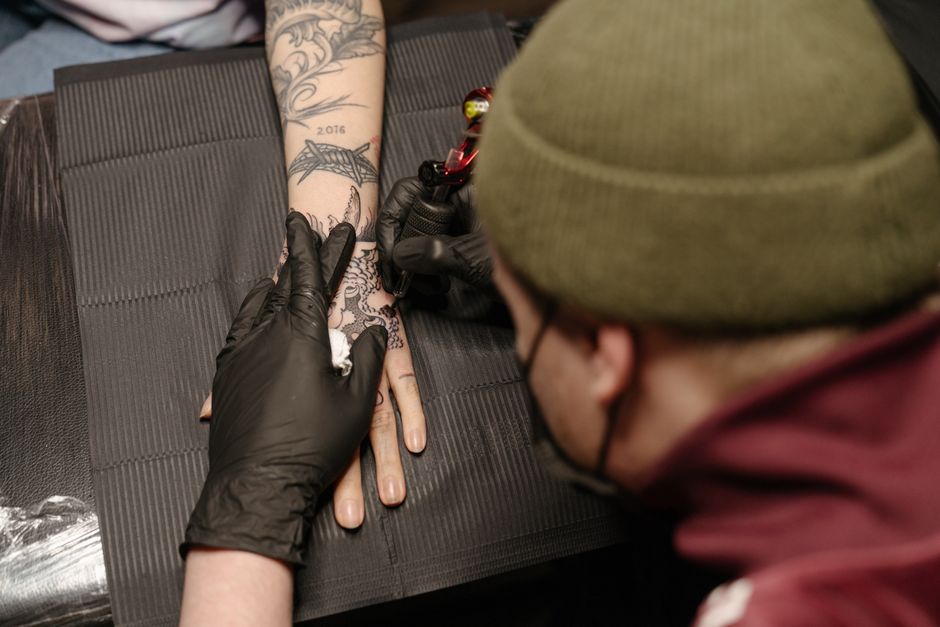 Close-up of a Tattoo Machine being used on scarred skin with careful technique Close-up of a Tattoo Machine being used on scarred skin with careful technique