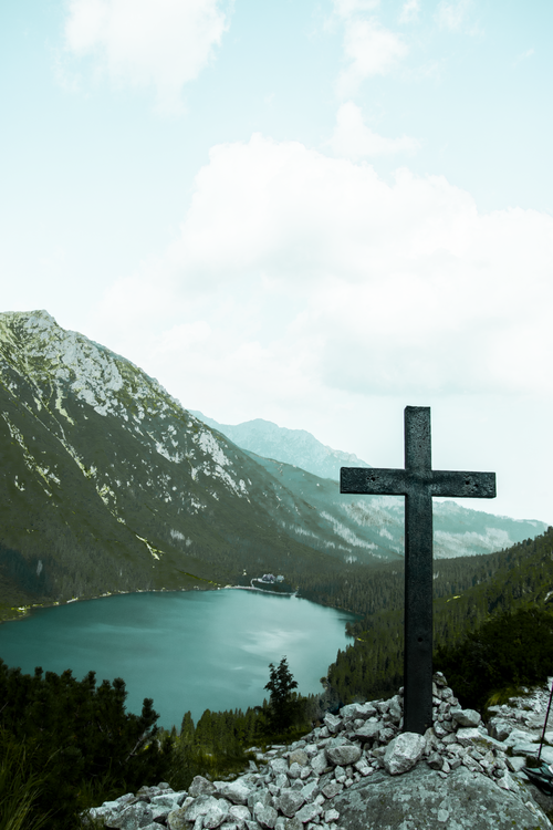 Free Serene mountain lake with cross and scenic landscape in Lesser Poland. Stock Photo