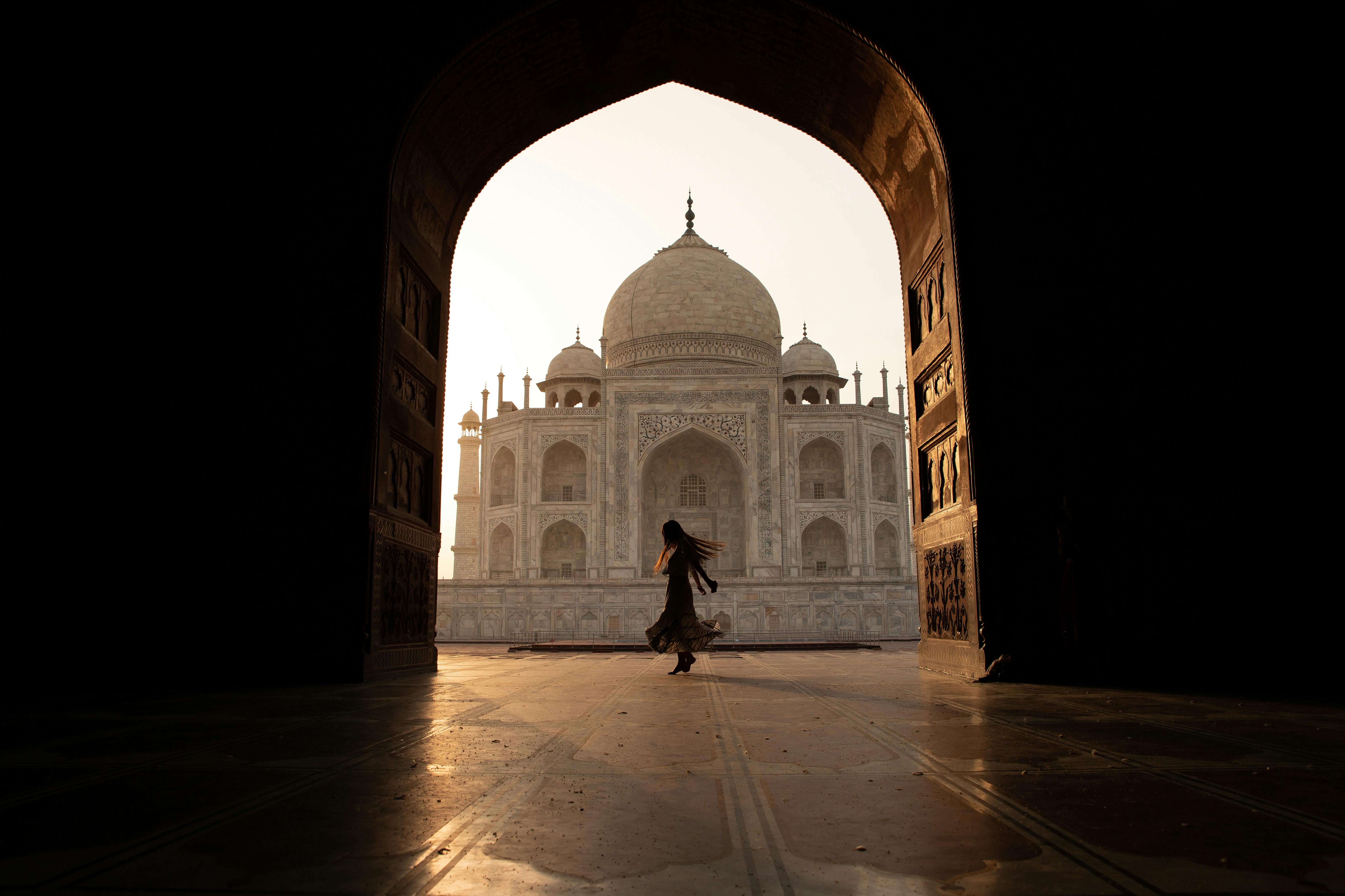 woman danicng under an arch