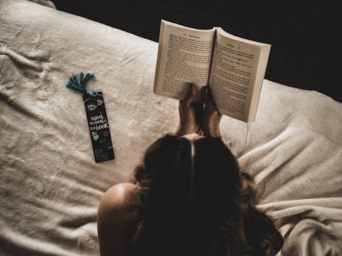 Free Photo Of Woman Reading Book On Bed Stock Photo