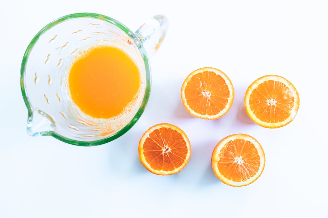 Free Photo Of Sliced Orange Beside Glass Pitcher Stock Photo