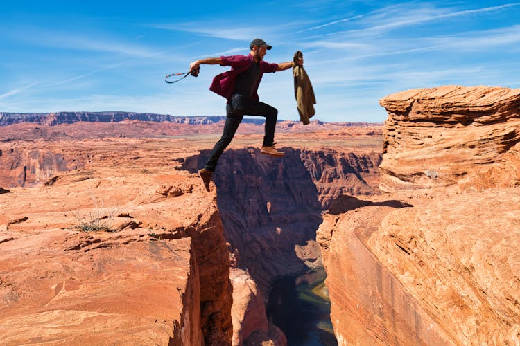 Man Jumping From One Cliff To Another 