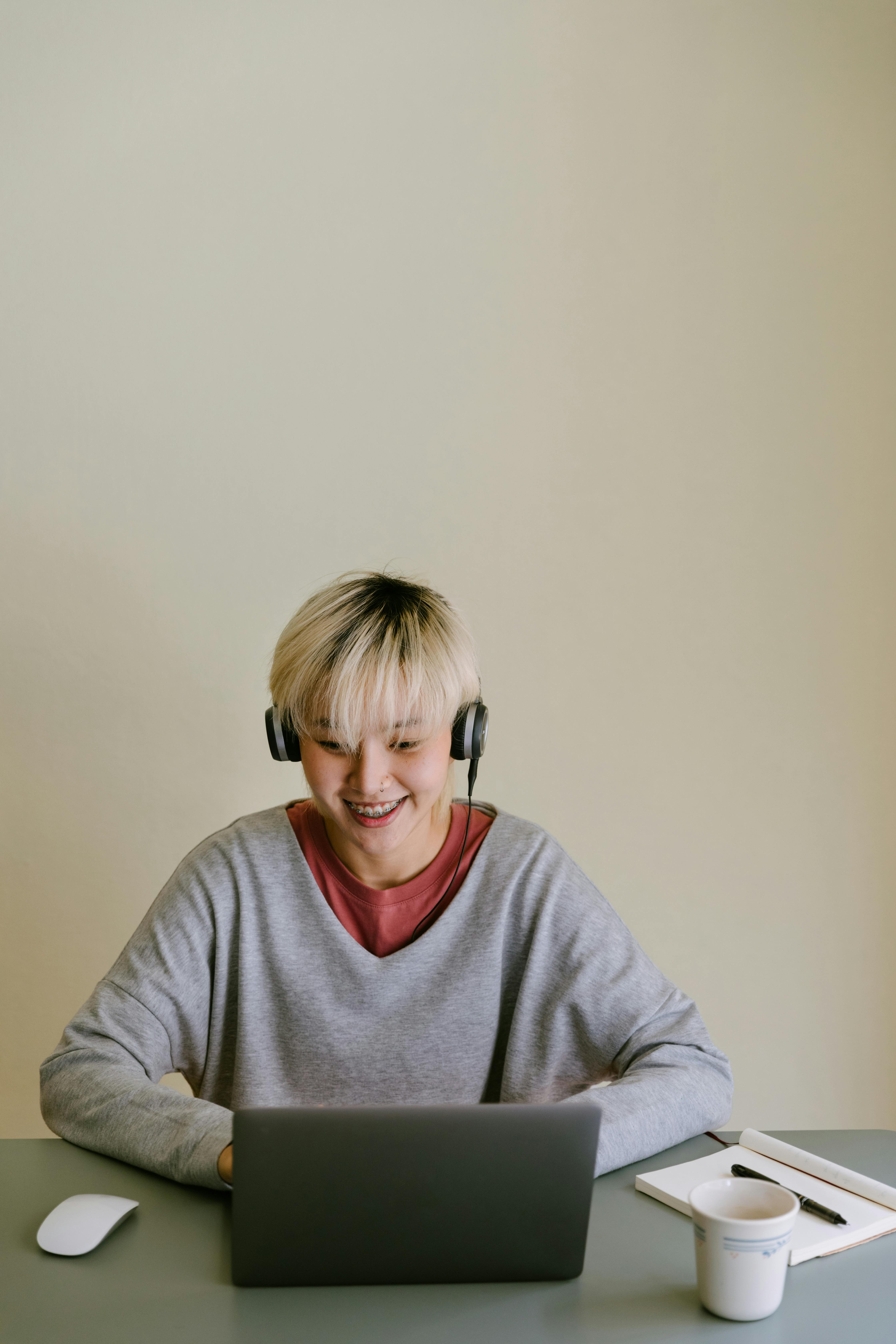 positive woman in headphones having video call