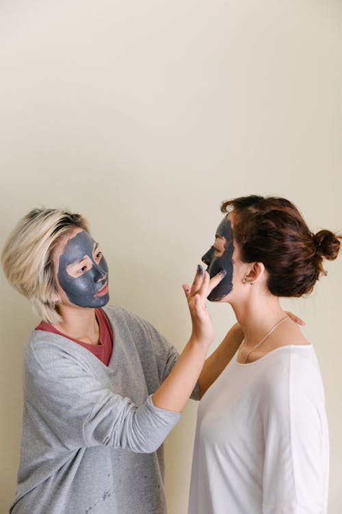 Woman applying a face mask 