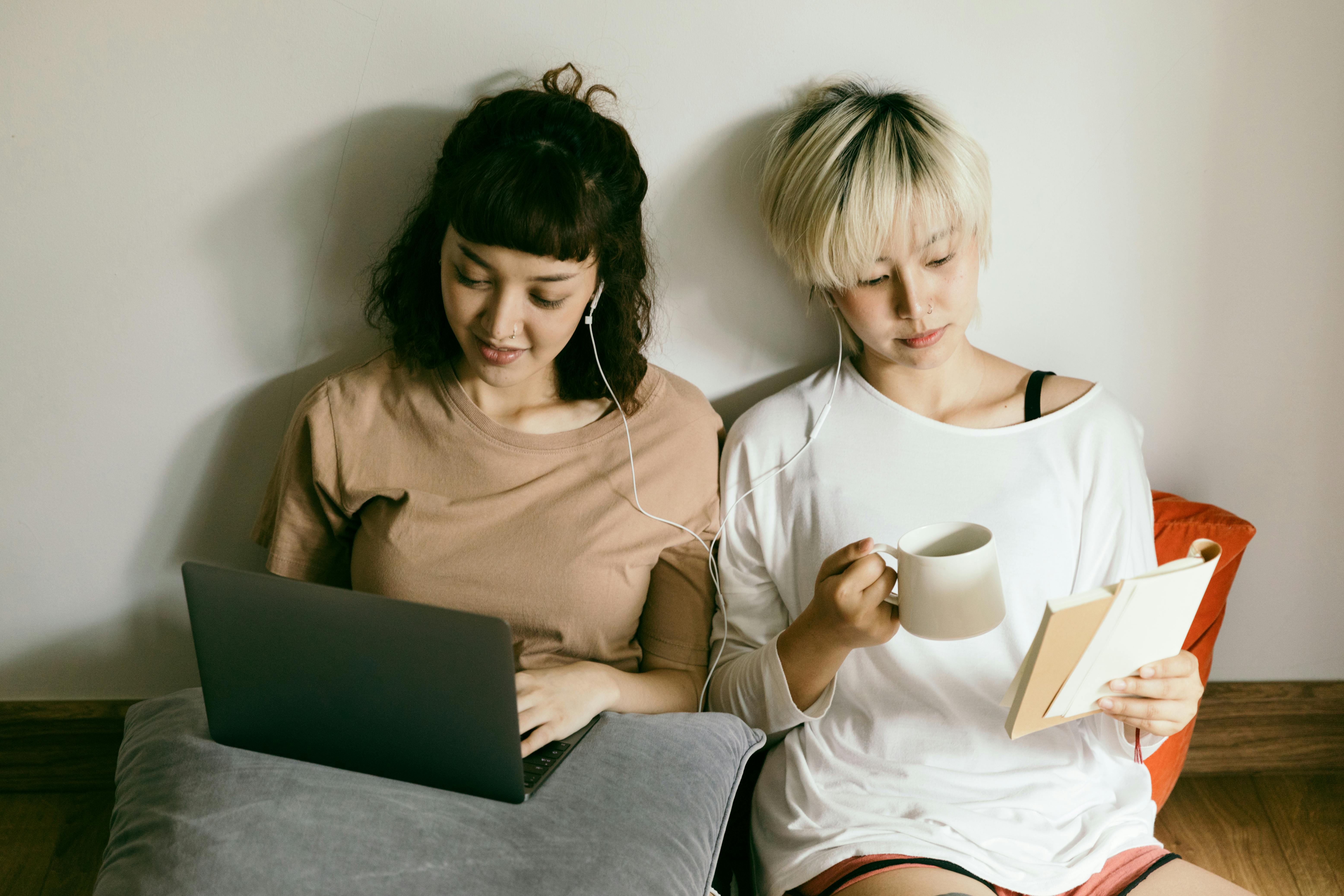 women sharing earphones