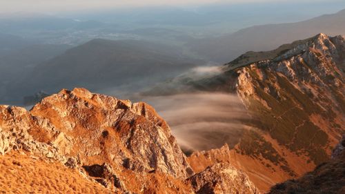 Free Dramatic view of the rugged mountain peaks under a foggy sky in Eisenerz, Austria. Stock Photo