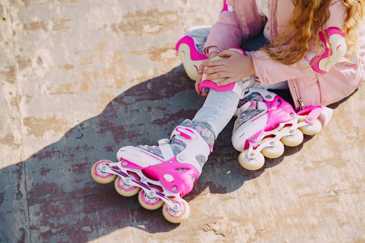 Crop Child In Roller Skates On Sport Playground