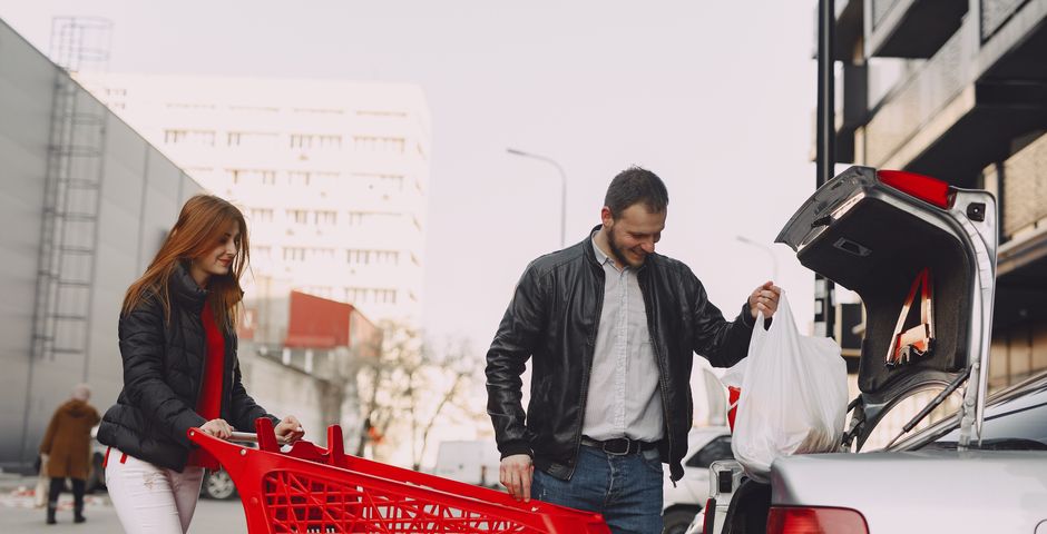 Loading shopping bags into a car boot — grocery bags and boxes are the most common way cockroaches ride in