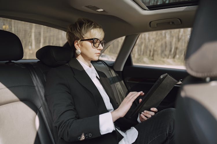 Serious Woman Using Tablet In Car