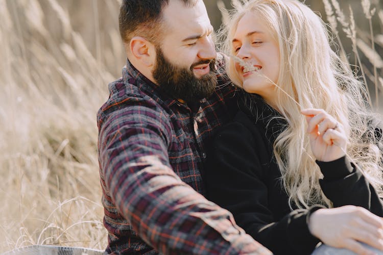 Cheerful Girlfriend Tickling Happy Boyfriend With Ear Of Wheat