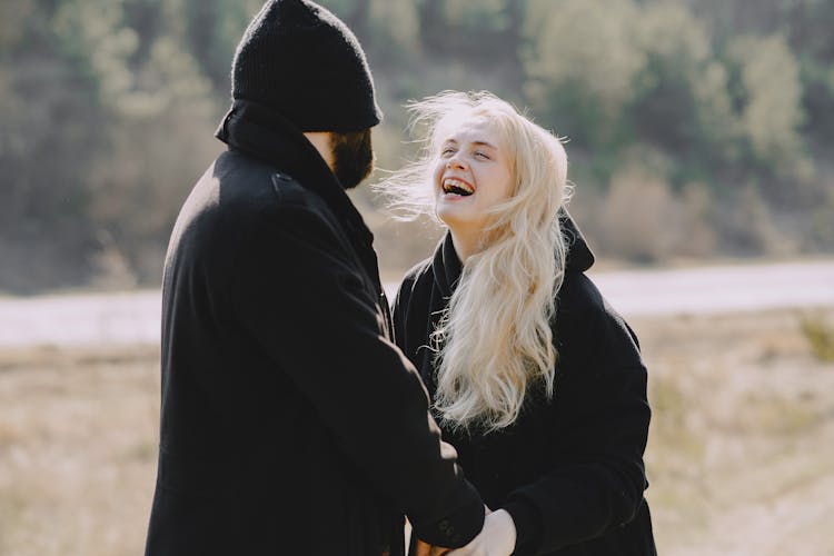 Happy Couple Holding Hands And Walking In Spring Countryside