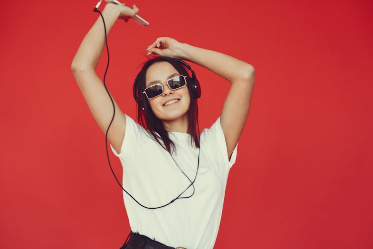 Cheerful Young Woman Listening To Music And Dancing