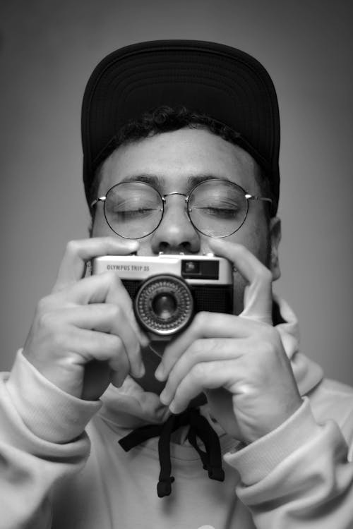 Monochrome Photo Of Man Holding Camera