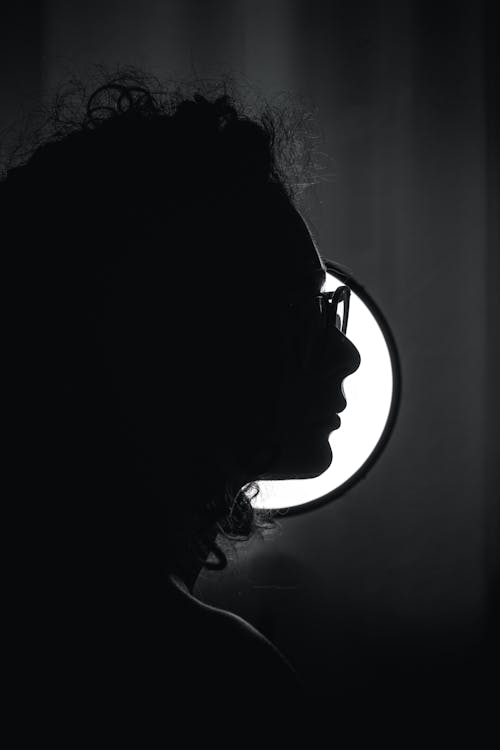 Grayscale Photo of a Person Wearing Sunglasses