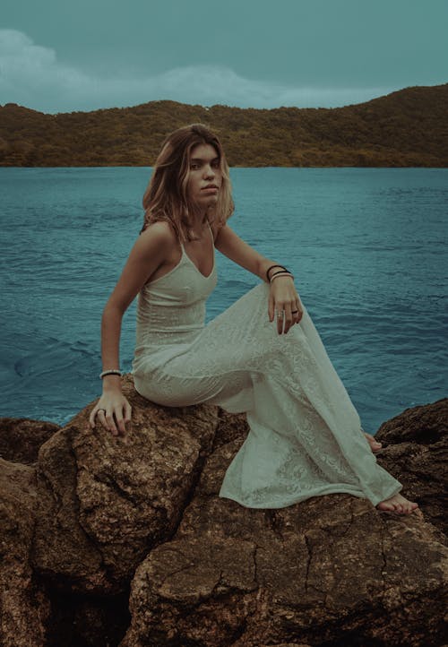 Photo Of Woman Sitting On Rock 