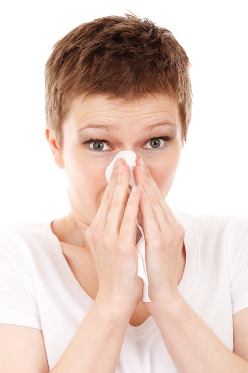 Short Red Hair Woman Blowing Her Nose